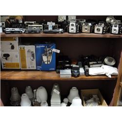 Shelf of vintage cameras and new light fixtures