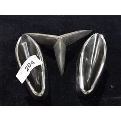 Pair of vintage car bumpers and hood ornament