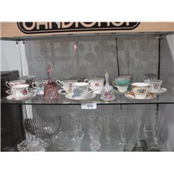 Shelf lot of teacups and bells