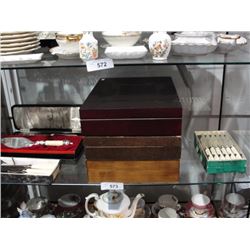 Shelf of flatware canteens, cake servers and silverplate knife sets