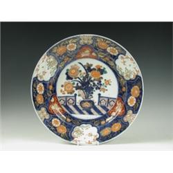 An Imari dish after an early 18th Century original, painted with a vase of flowers within an e...