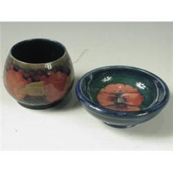 A Moorcroft bowl in the Pomegranate pattern, 7cm high, and another, decorated with a pansy, 11...