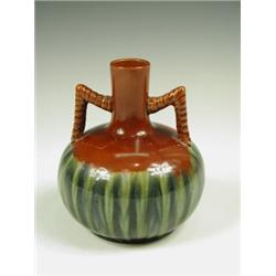 An Art pottery twin-handled vase, with a red and two-tone, green-streaked body, possibly Ault,...