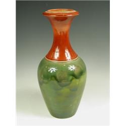 An Art pottery shouldered vase with a flared neck, in a two-tone glaze of red and green, unmar...