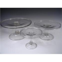 Three George III hand blown glass tazzas of graduating size, each with a shallow rim and a Sil...
