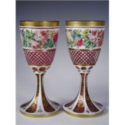 A pair of l9th Century Bohemian glass goblets, the cranberry glass with white overlay decorate...