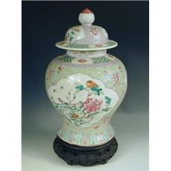 A late 19th Century Cantonese baluster vase and cover with characteristic decoration, on an as...