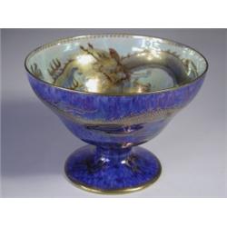 A Wedgwood lustre pedestal bowl decorated on the interior and exterior with a gilt dragon chas...