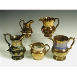 Five late 19th Century copper lustre jugs, each of different form, three with polychrome decor...