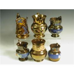 Six copper lustre jugs, five of baluster shape, one moulded with dancers, late 19th/20th Centu...