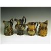 Image 1 : Four copper lustre jugs, two with moulded figures, one of shaped baluster form and one of plai...