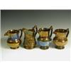 Image 1 : Four copper lustre jugs, three of baluster shape with coloured bands, and one moulded with dan...