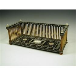 An Indian bookstand, of sandalwood and rosewood, inlaid with ivory with a pierced 3/4 quarter...