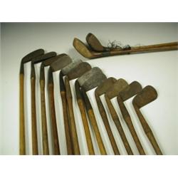 Twelve early 20th Century golf irons, mostly stamped, together with two clubs, two golf bags a...