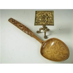 A miniature brass tripod table, the hinged top cast with a scene of monkeys in a wood, on a ba...