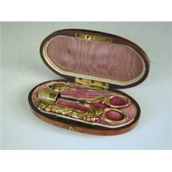 A 19th Century burr yew wood oval necessaire with mother of pearl inlay, with a velvet fitted...