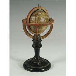 An early 19th Century miniature terrestrial globe on an ebonised stand, 6.5cm diameter, inscri...