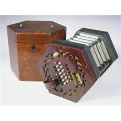 A Louis Lachenal Patent concertina with a rosewood fretwork case and leather bound bellows, wi...