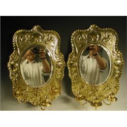 A pair of early 20th Century embossed brass wall sconces, each with 3 candle brackets, 48cm hi...