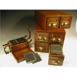 Three mahogany cases of black and white glass lantern slides, featuring India, Nepal, Scandina...