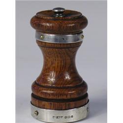 An Edwardian oak and silver mounted pepper mill, hallmarked Birmingham 1908, 9cm high Est....