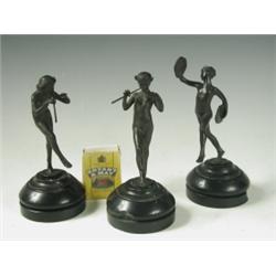 Three late 19th Century miniature bronze figures each representing a fawn playing a musical in...
