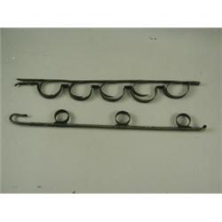 A pair of wrought iron wall mounted gun racks Est. 150/200...