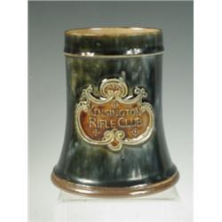 A Royal Doulton stoneware tankard with an applied cartouche, 'Kensington Rifle Club' 13cm high...