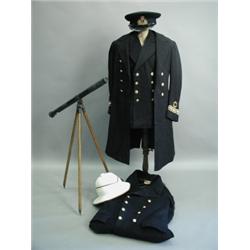 A Second World War naval officers uniform together with other uniforms, and Siemens Bro's & Co...