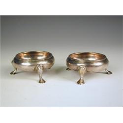A pair of George III silver salts, each of circular form, raised on three pad feet, makers mar...