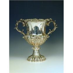 An early Victorian silver cup, with applied relief foliate decoration on a campana shaped body...