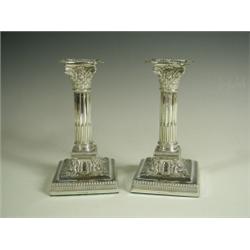 A pair of Edwardian silver dwarf candlesticks, modelled as half fluted corinthian columns, She...
