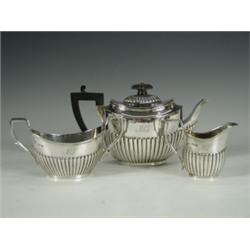 A Victorian silver three piece teaset of half reeded form with an ebonised handle and knob, 19...
