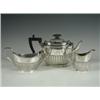 Image 1 : A Victorian silver three piece teaset of half reeded form with an ebonised handle and knob, 19...