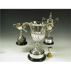 Four silver trophies, 1 with part wrythen body hallmarked London 1898, a 2 handled lidded trop...