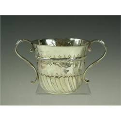 An early 18th Century silver twin handled porringer, with a rope style band flanked by struck...