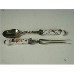 A continental fork and spoon with a gilt bowl and tines, 'jewelled' collars and Meissen style...