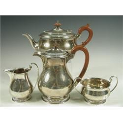 An Art Deco four piece silver tea service hallmarked London 1931, retailed by Harrods, 58ozs,...