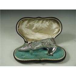 A modern silver shoe with foliate embossed and chased decoration, makers mark GN, RH, Chester,...
