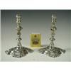Image 1 : A pair of silver taper sticks, in early 18th Century style, by Garrard & Co Ltd., 1934, 12cm h...