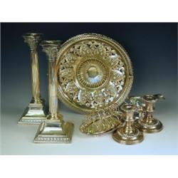 A pair of electro plated nickel silver corinthian column candlesticks, the stems half fluted o...