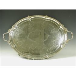 A large Victorian silver plated 2 handled tray on 4 scrolling feet, 61cm diameter excluding ha...