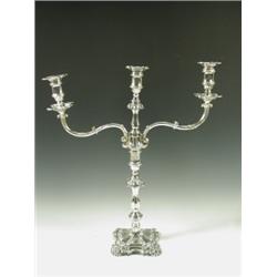 A large Victorian silver plated candelabrum with two scrolled branches on a cast square loaded...