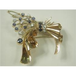 A sapphire and diamond spray brooch set in yellow metal, (tests gold) with a safety chain, 5cm...