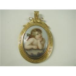 A painted porcelain plaque pendant with mother of pearl back and within a yellow metal scroll...