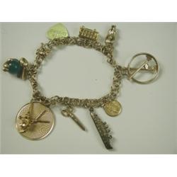 A 14ct gold charm bracelet with 10 various charms, 18cm long Est. 100/150...
