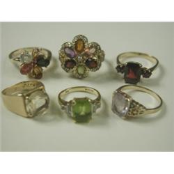 Six gemset rings: peridot and diamond set in 18ct gold, amethyst and citrine solitaires, a gar...