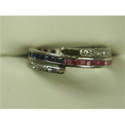 A triple eternity ring, the cental band half channel set with rubies, half with sapphires with...