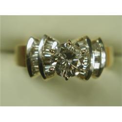 A diamond solitaire ring, set with a central stone of approx 0.85ct, with baguette diamond set...