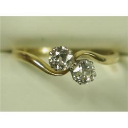 A 2-stone diamond crossover ring set with old cut stones in 18ct gold and platinum, size Q 1/2...